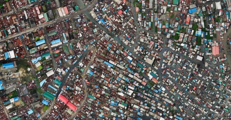 Stop vlogging Makoko floating village Aerial view of Makoko Slum in Lagos Nigeria scaled